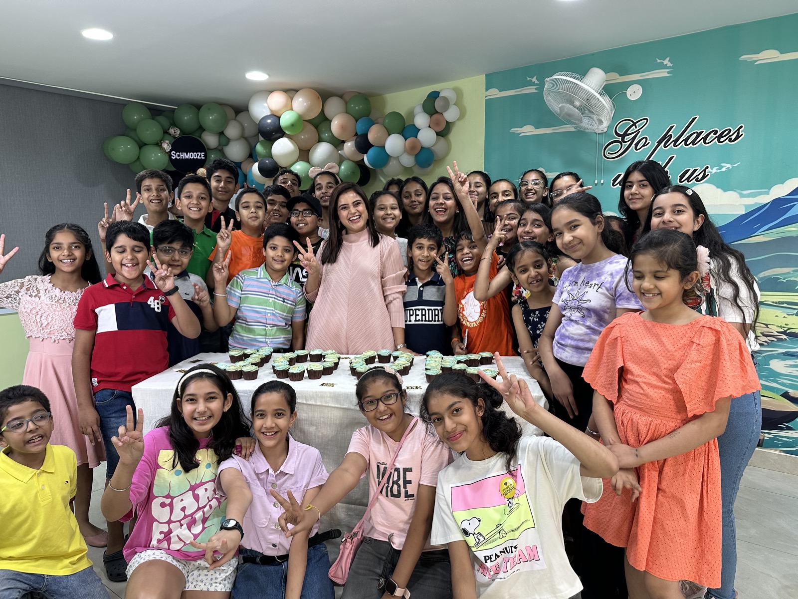 Students celebrating a milestone with cupcakes and balloons